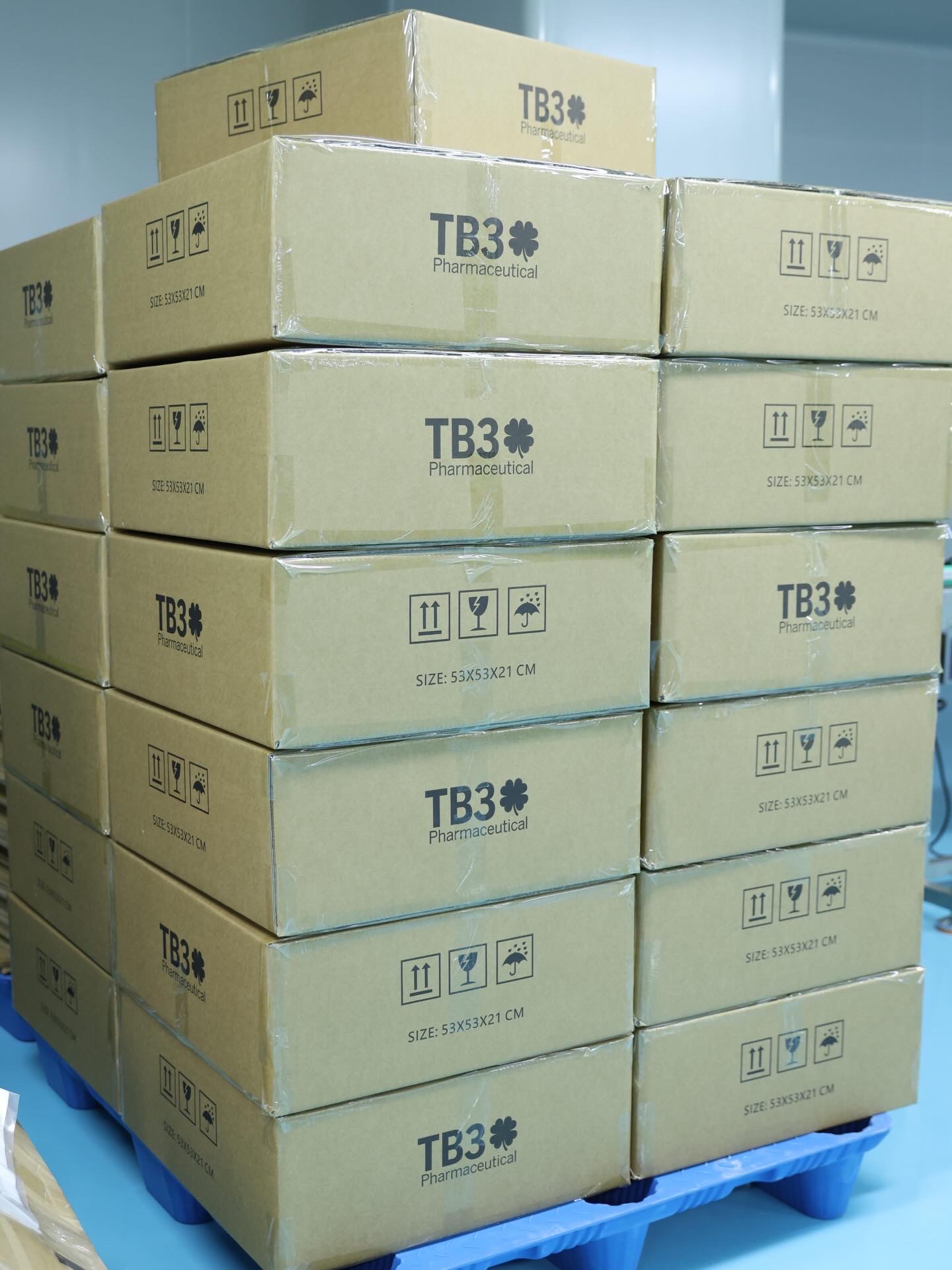 Pallet of shrink-wrapped TB3 Pharmaceutical cartons, stacked at the factory.